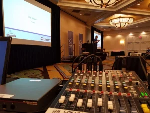 Audio visual control with sound mixer and stage setup for live corporate presentation by Lucas Productions USA