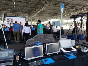 Outdoor live event with AV equipment, laptops, and video production setup by Lucas Productions USA
