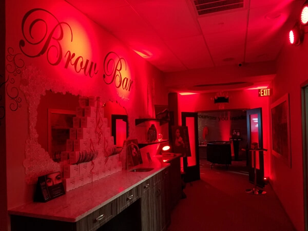 Radiance Casino Bar event setup with dramatic red uplighting and makeup product displays