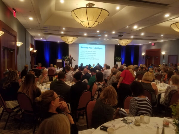 VSPC Business conference with keynote speaker presenting marketing plan to audience