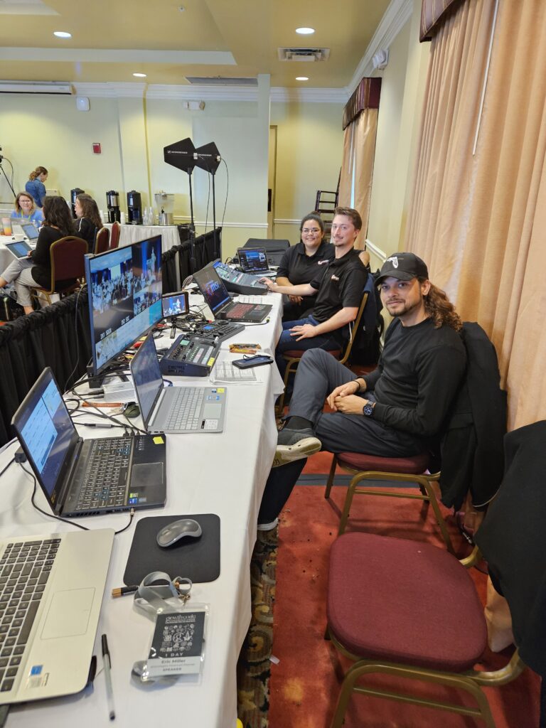 AV technicians from Lucas Productions USA operating laptops, mixers, and video equipment for live event production