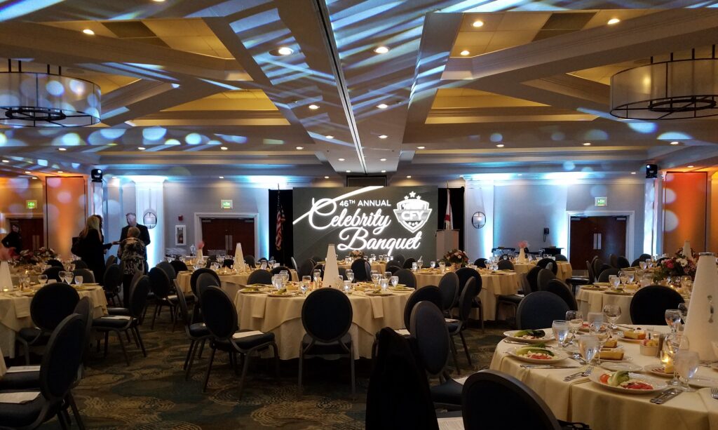 Lucas Productions USA LED video wall setup at Celebrity Banquet with elegant stage backdrop and event lighting.