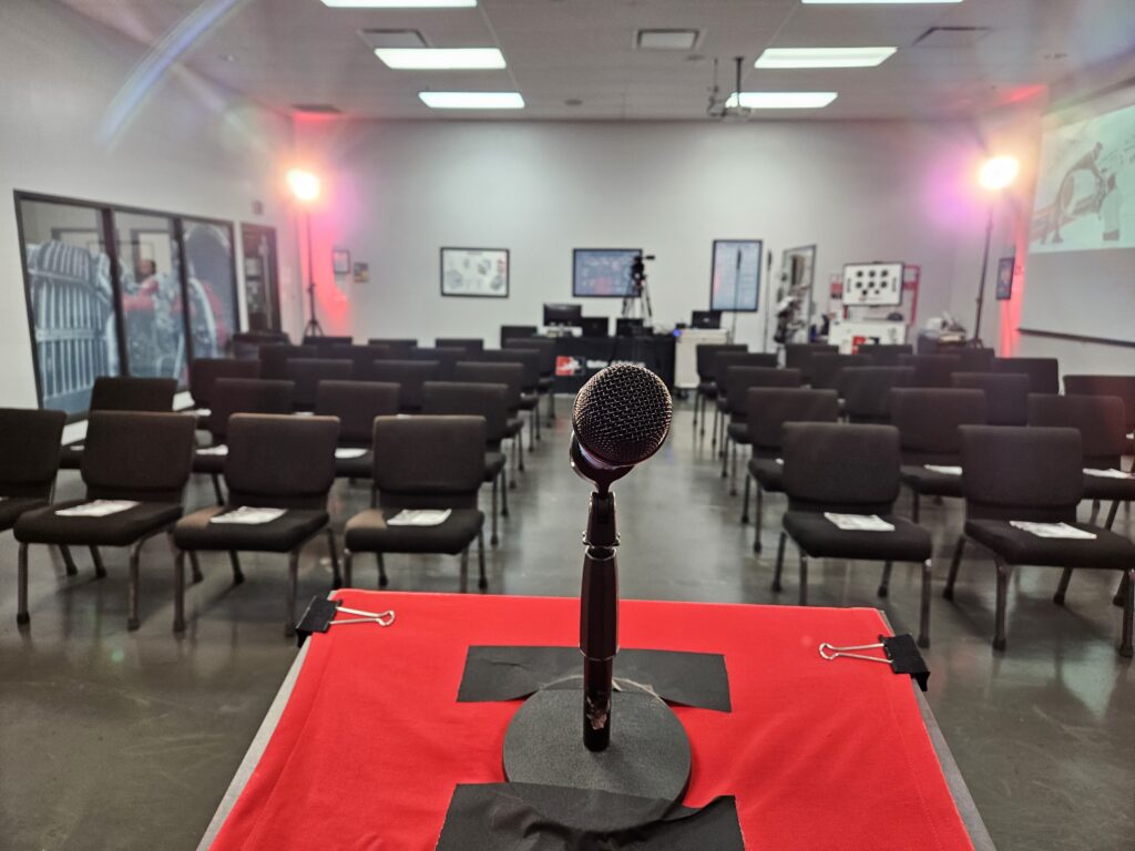 Microphone and podium setup by Lucas Productions USA for conference presentation with professional stage lighting