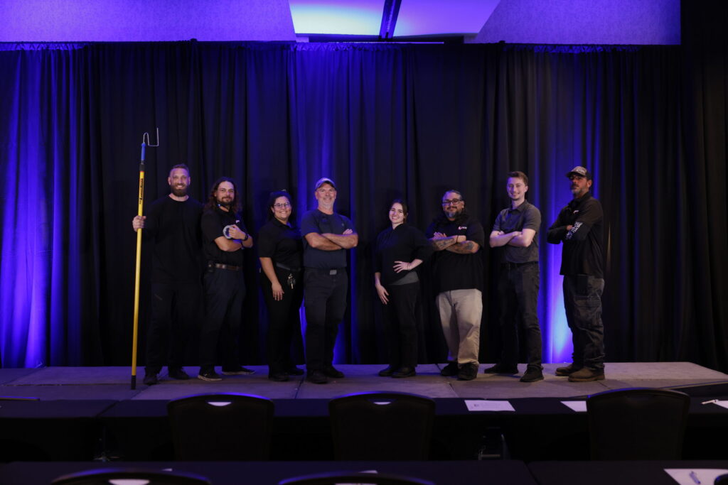 Lucas Productions USA event production team on stage with professional AV setup and lighting.